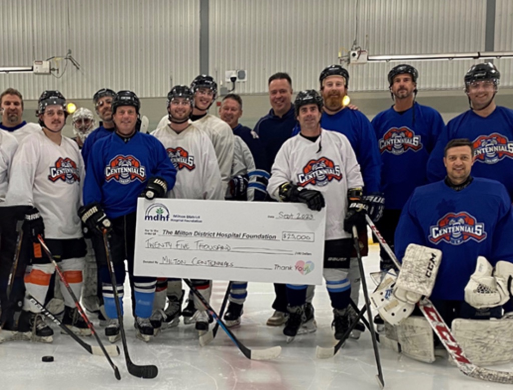 Milton Centennials team with check