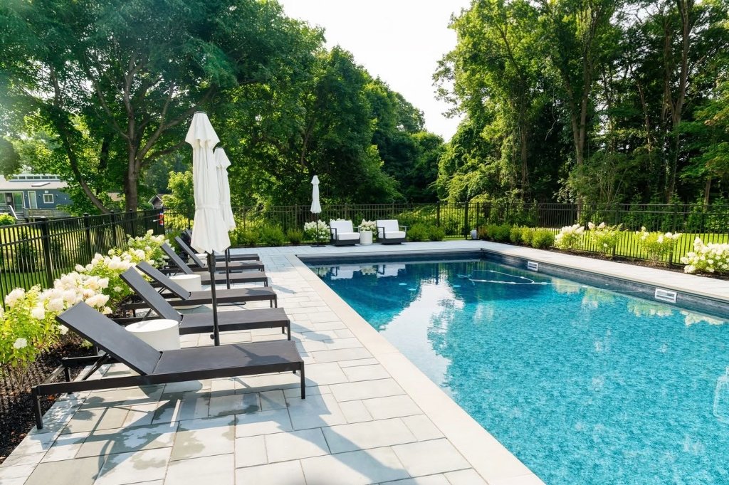Pool with lounge chairs and landscaping