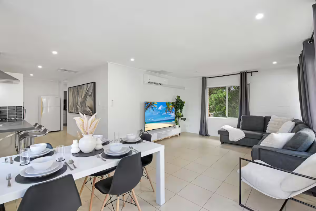 Open-plan living and dining area with large TV