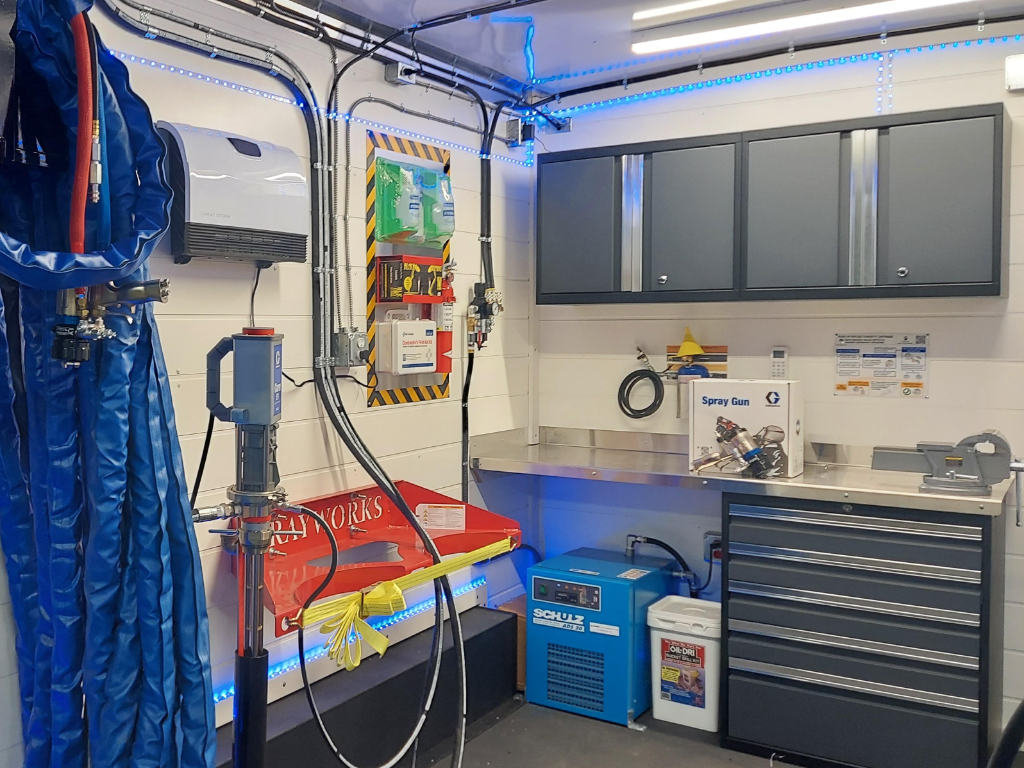 Professional service workspace with tool storage, workbenches, and equipment organization