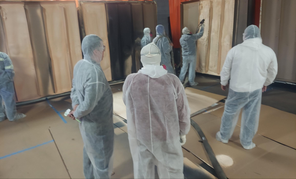 Professional spray foam application technique demonstration on building insulation