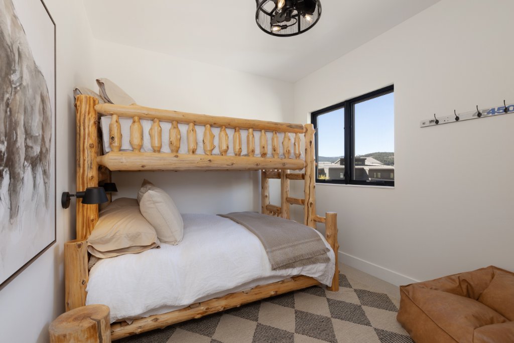 Bedroom 4 — rustic log bunk beds with mountain views
