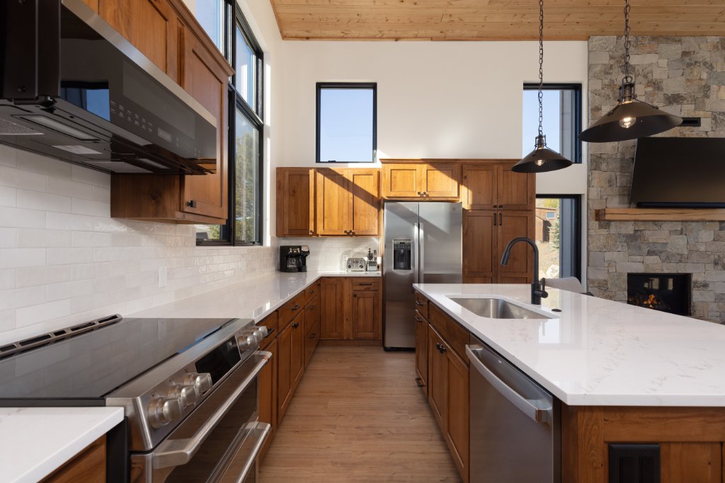 Kitchen — stainless appliances, wood cabinets & subway tile backsplash