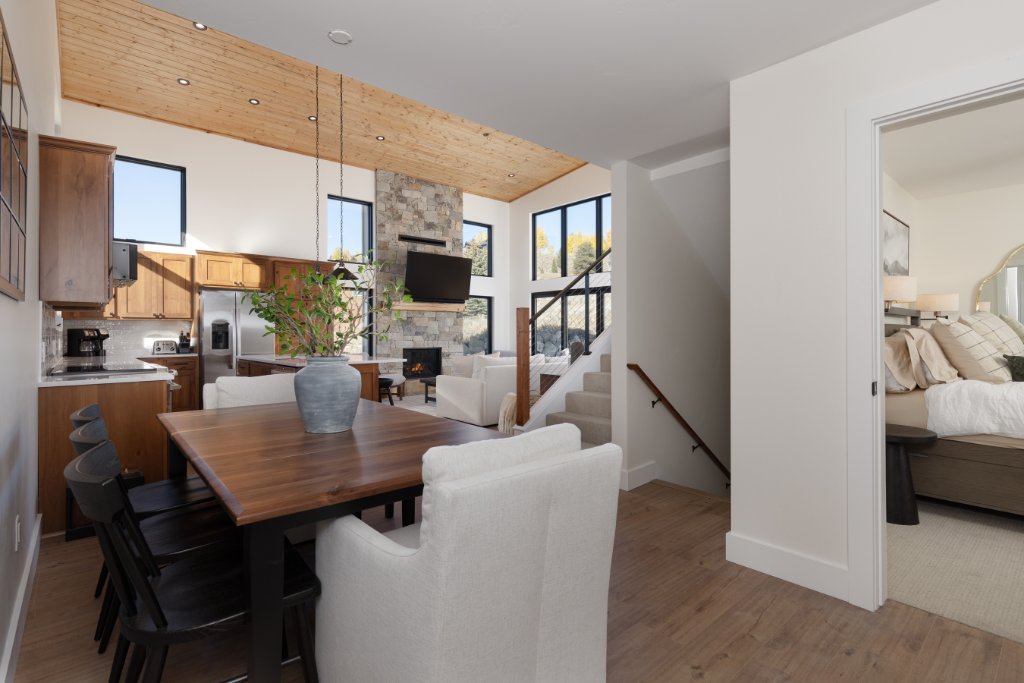 Dining room — open to living room with stone fireplace