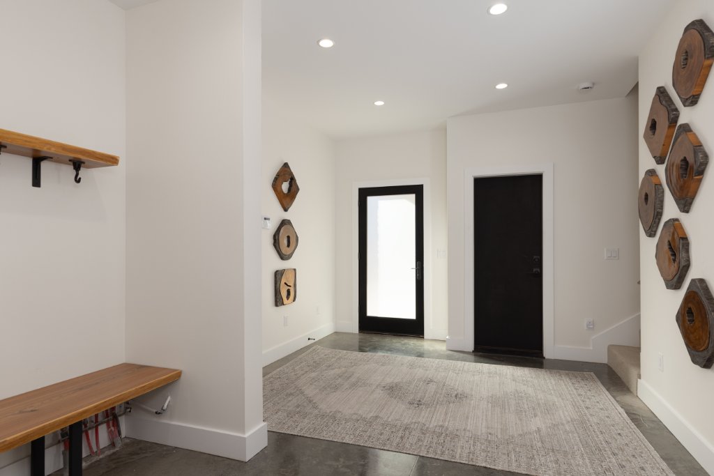 Entryway — foyer with wood art & front door