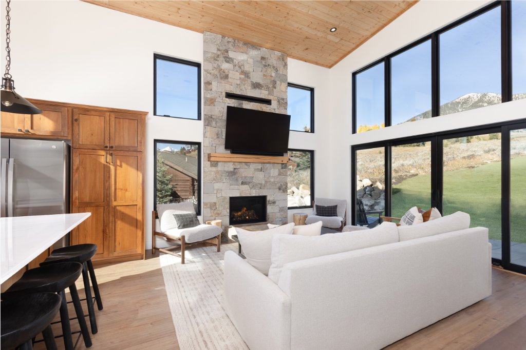 Living room — stone fireplace with TV & sliding doors to patio
