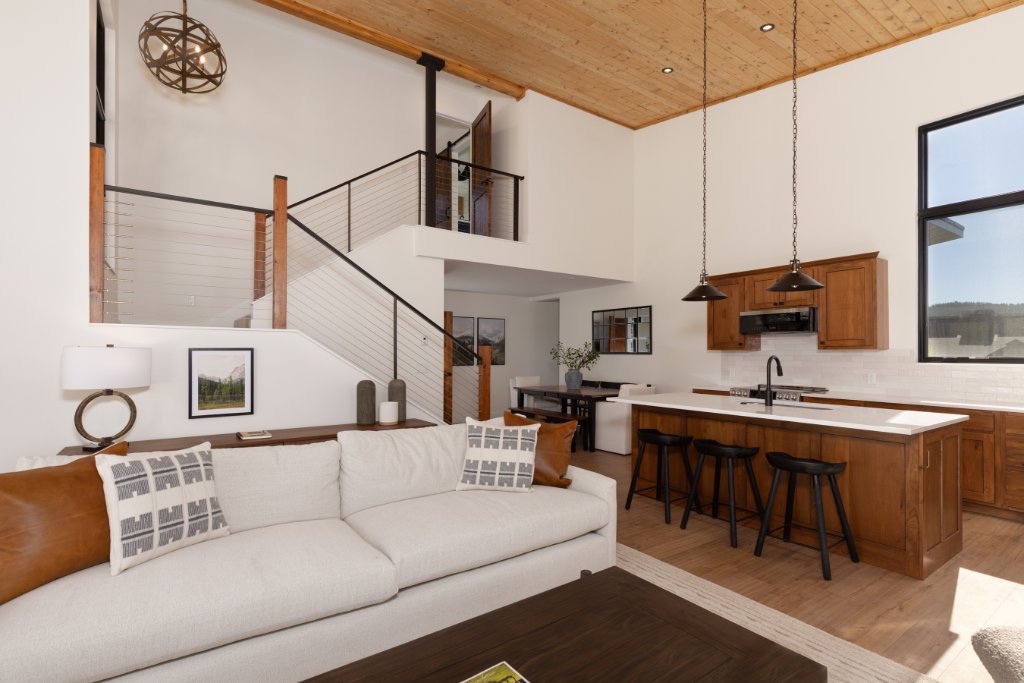 Living room — sofa with views to kitchen, staircase & loft