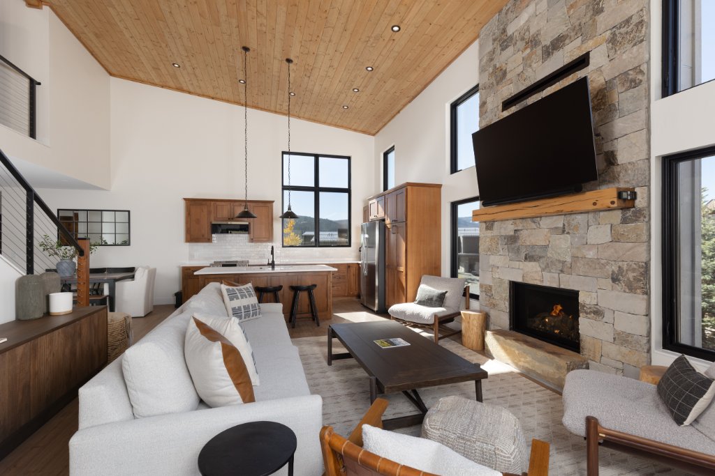 Living room — open to kitchen with vaulted wood ceiling & fireplace