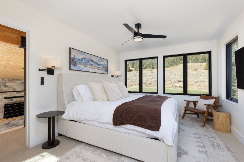Bedroom 1 — king bed with mountain views & fireplace