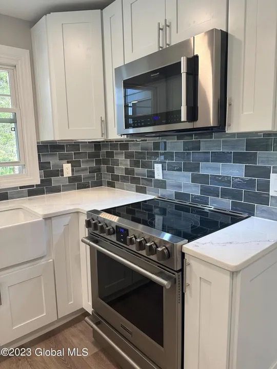 Kitchen Renovation – White Cabinets - Complete kitchen remodel with tile backsplash and quartz counters
