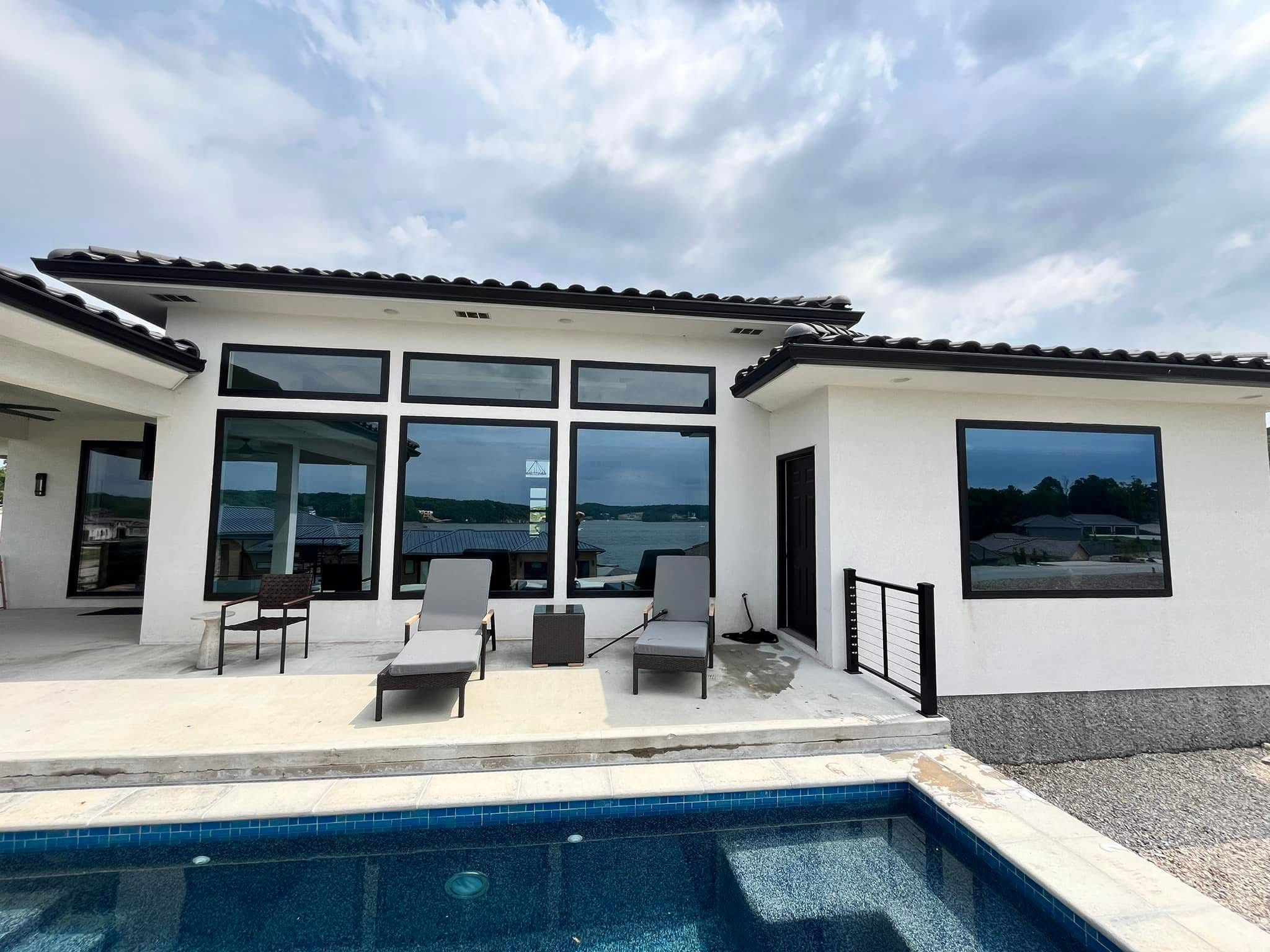 Modern home with sparkling windows by pool
