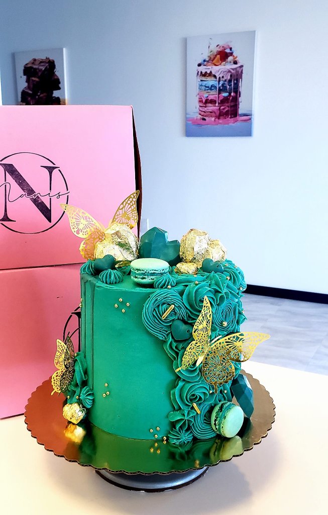 Emerald green cake with gold butterflies and macarons