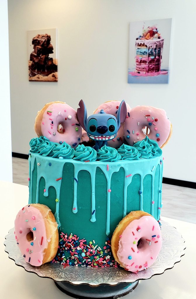 Teal Stitch-themed drip cake with donuts