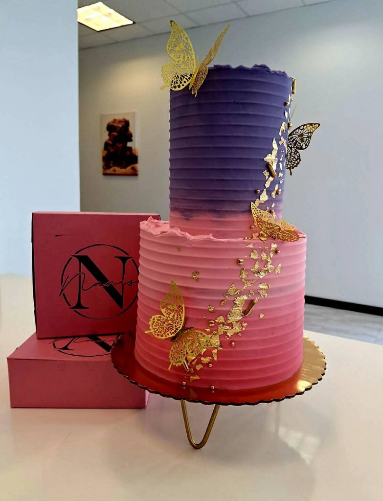 Pink and purple ombre two-tier cake with gold butterflies