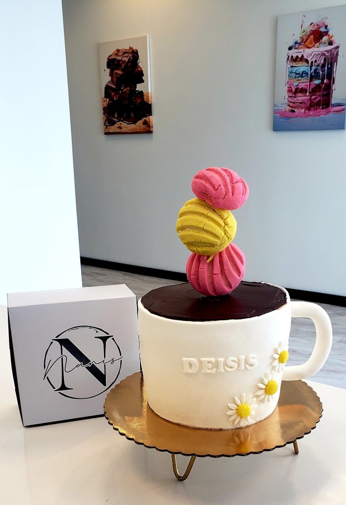 Mug-shaped cake named Deisis with stacked macarons