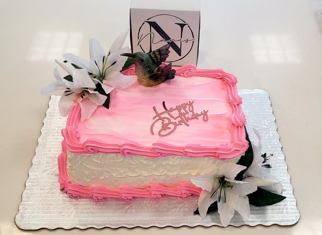 Pink Happy Birthday sheet cake with hummingbird topper