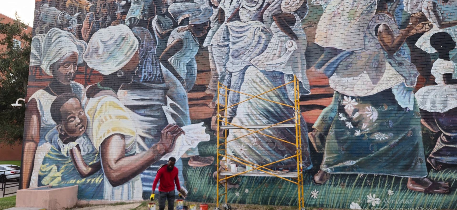 Jubilee, a mural reproduction of John T. Biggers' Jubilee – Ghana Harvest Festival, painted by Adeodunfa with Linda Hinojos