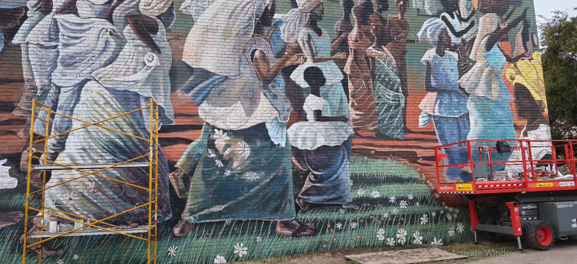 Jubilee, a mural reproduction of John T. Biggers' Jubilee – Ghana Harvest Festival, painted by Adeodunfa with Linda Hinojos
