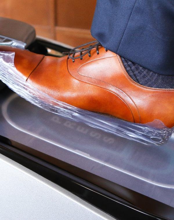 SoleMate SM-76C automatic shoe cover dispenser in use