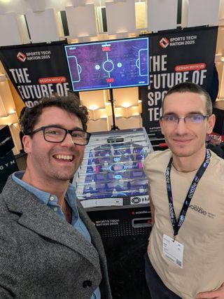 Two people in front of a lit screen at a Sports Tech Nation event