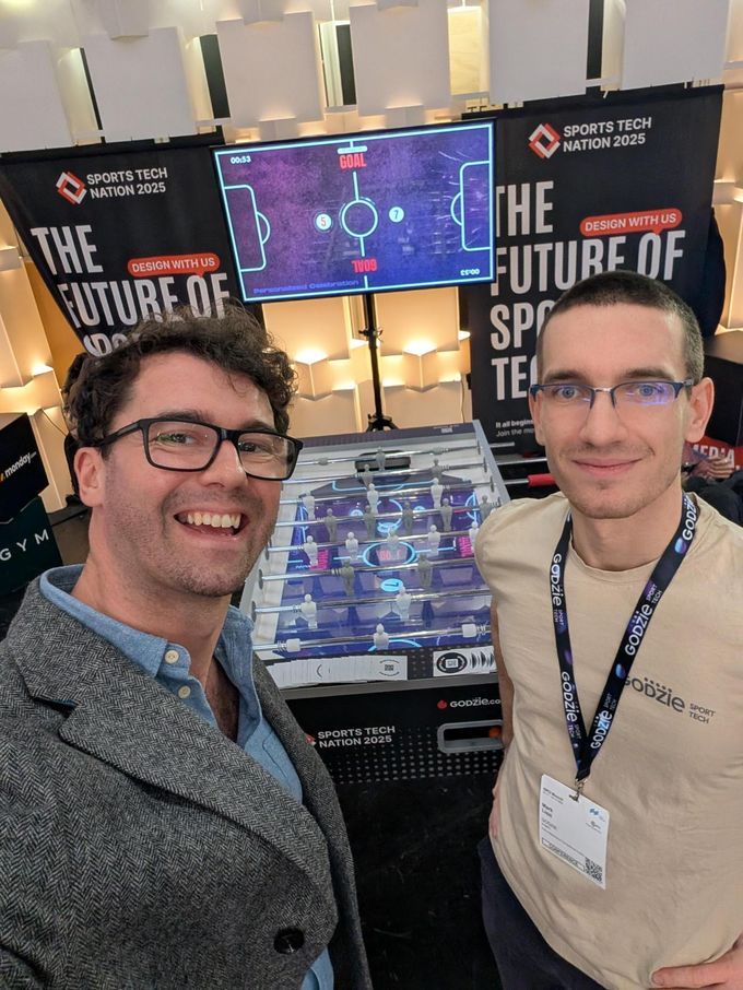 Two people in front of a lit screen at a Sports Tech Nation event