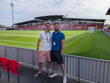 Standing pitchside at Wrexham, the empty stand behind