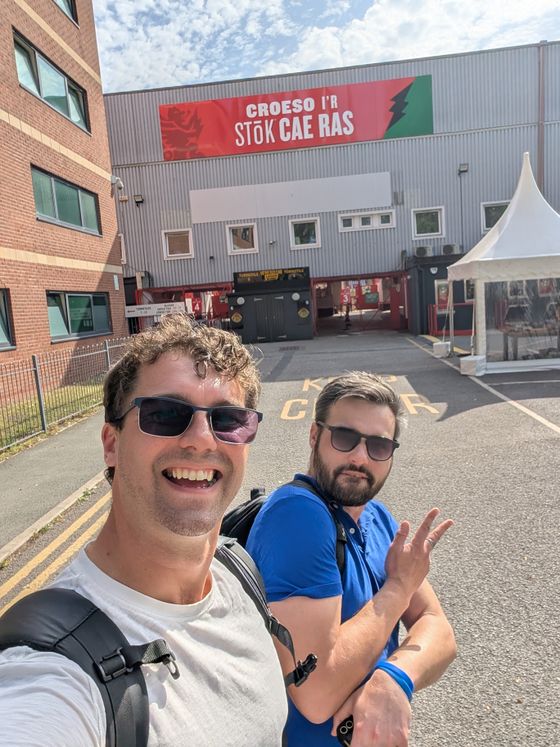 Two people larking about outside the Wrexham stadium car park on launch day