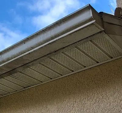 Dirty gutter soffit before cleaning