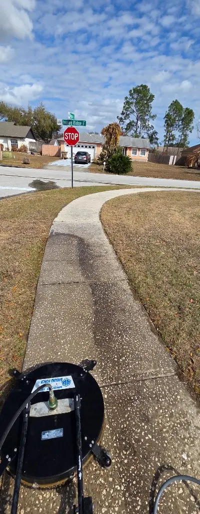 Sidewalk pressure washing in progress
