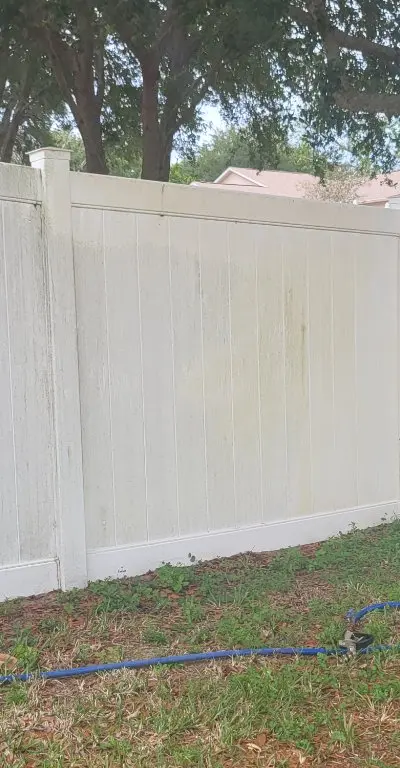 Vinyl fence in progress cleaning